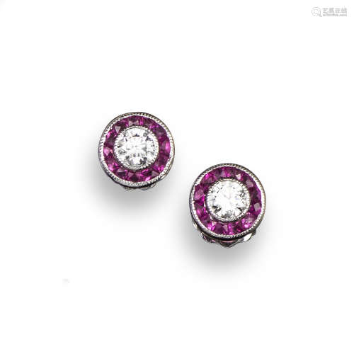A pair of ruby and diamond ear studs, the circular-cut diamonds are set within a surround of tapered