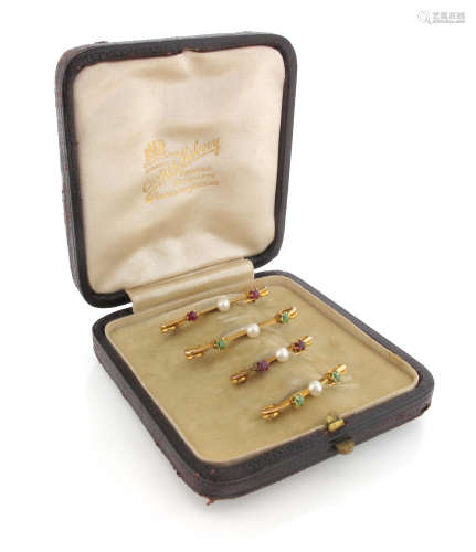 A set of four graduated gold brooches, each centred with a seed pearl, two with a pair of rubies and