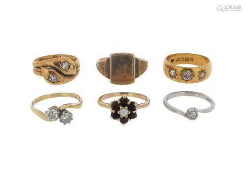 A group of six gold and gem-set rings, including a diamond two stone cross-over ring, size P, a