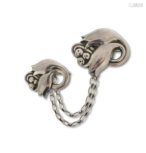 A silver brooch set by Georg Jensen, design no. 100 & 100A, c1945-1951, formed as large and small