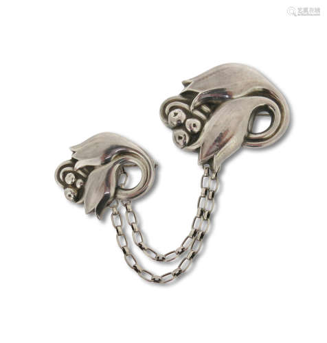 A silver brooch set by Georg Jensen, design no. 100 & 100A, c1945-1951, formed as large and small