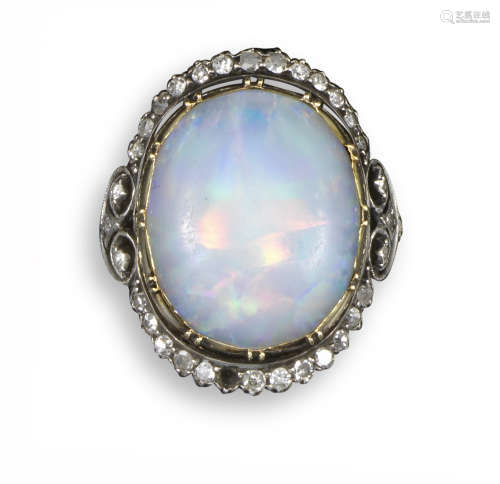 A late 19th century opal and diamond cluster ring, the oval opal cabochon set within diamond