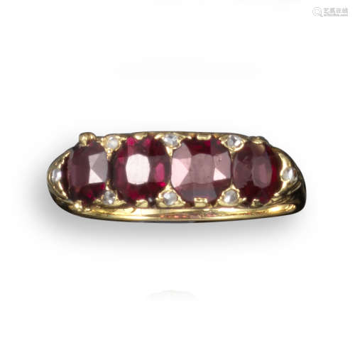 A late 19th century garnet and diamond four stone ring, the four garnets set with diamond pointers