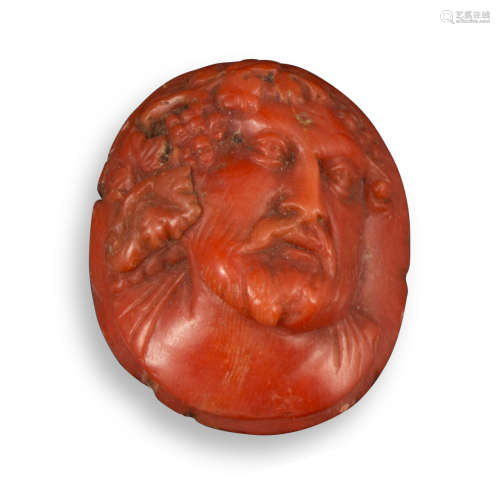 A carved coral cameo depicting Bacchus, c1800, bearded and wearing fruiting vines, and with a