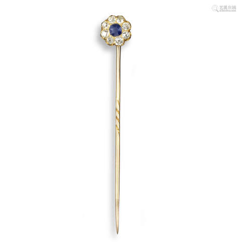 A sapphire and diamond cluster stickpin, the cushion-shaped sapphire is set within a surround of