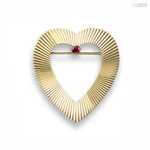 A gold heart brooch by Tiffany & Co, with engine-turned decoration and set with a ruby in yellow