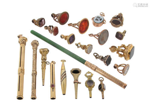 A collection of gold propelling pencils and fob seals, including a ruby and diamond-set gold pencil,
