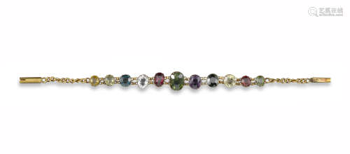 An Edwardian multi-gem-set gold bracelet, set with eleven graduated gem stones including tourmaline,