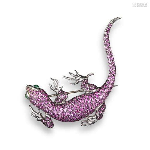 A gem-set gold lizard brooch, pave-set with rubies and with emerald eyes in white gold, 5cm long