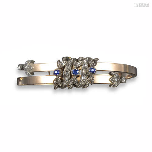 A Victorian sapphire and diamond bangle, set with a central panel of sapphire and diamond laurels in