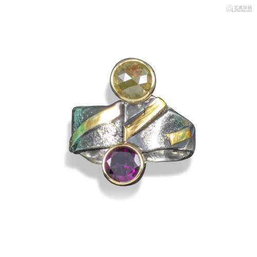 A gem-set abstract silver ring, the abstract silver and gold ring set with a circular-cut garnet and