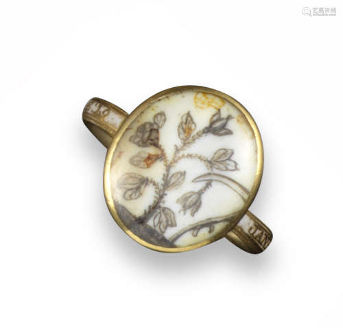 A George III mourning ring, the oval glazed locket displays a plant (possibly rose) with a