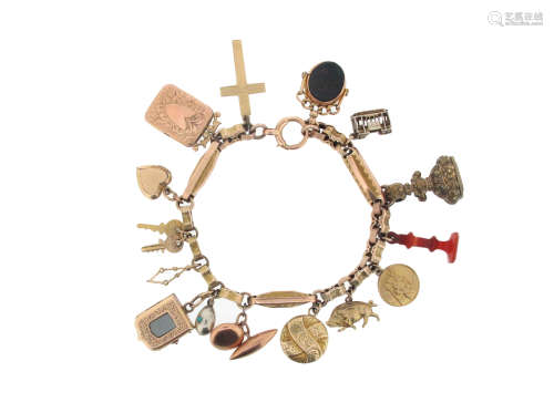 A gold charm bracelet, the fancy-link bracelet set with assorted charms including a double-sided
