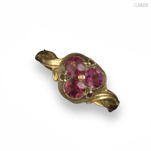 A 19th century gold ring, set with a trefoil of circular-cut garnets and with intertwining shank,