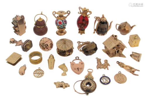 Twenty-three assorted gold and gold-mounted charms, including a merry-go-round, fairtytale