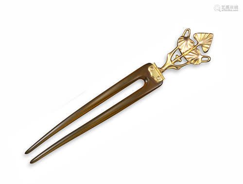 An early 20th century Egyptian revival hair pin, the horn two-prong pin is surmounted with a gold