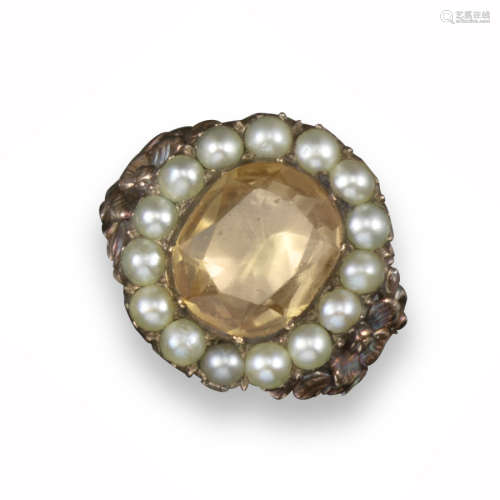 A 19th century topaz and seed pearl ring, the oval-shaped topaz set within a surround of seed pearls