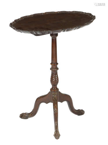 A mahogany tripod table in George II style, the oval tilt-top with a pie crust moulded edge, on a
