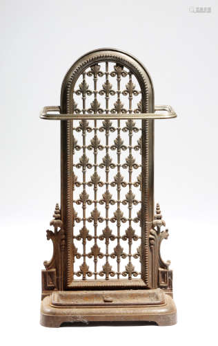 A Victorian cast iron stickstand in the manner of Dr. Christopher Dresser, with a lift-out tray,
