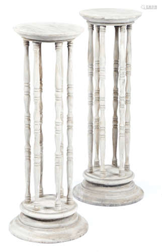 A pair of bleached beechwood hourglass shape stands, with turned spindle supports, 91cm high, 35.7cm