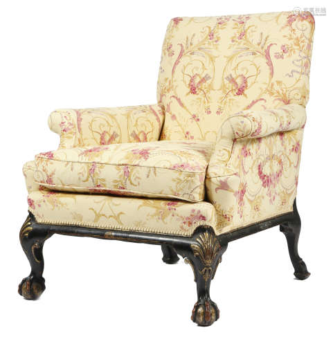 A black japanned and parcel gilt armchair in 18th century style, the padded back above scroll