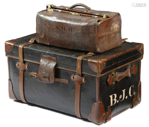 A black canvas and leather trunk by Finnigans, with brass mounts painted with initials 'B. J. C.'