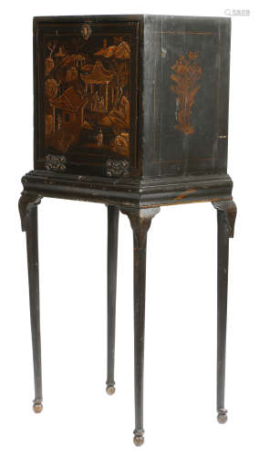 A black japanned cabinet on stand, decorated in gilt with chinoiserie scenes with figures and