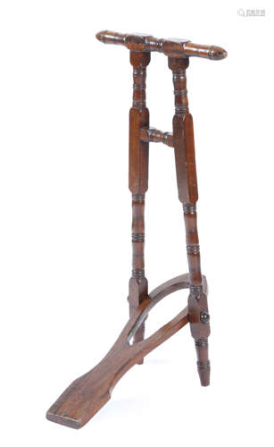 A mahogany boot jack by Tom Hill, with an ivorine plaque, inscribed 'TOM HILL LONDON S.W.1. (