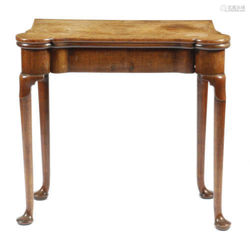 A George II red walnut card table, the hinged top with eared corners revealing a baize lined