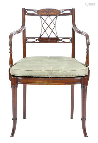 A mahogany open armchair in Regency style, the reeded lattice splat back carved with an oval pattera