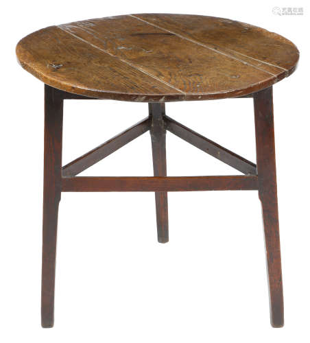 A George III oak cricket table, the triple boarded top on stretchered supports, 68.5cm high, 70.