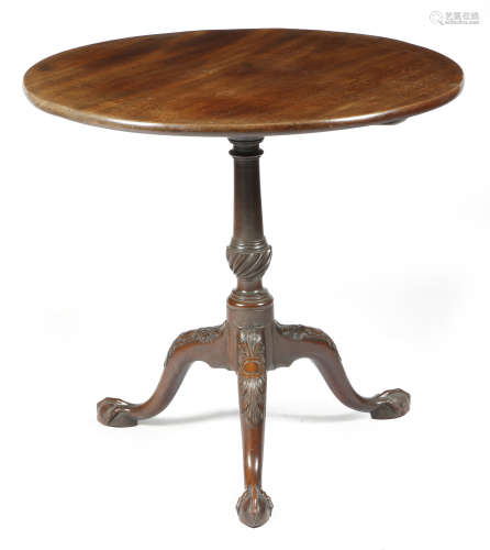A George II mahogany tripod table, the circular tilt-top on a fluted urn turned stem, on leaf and