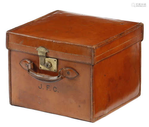 A brown leather hat box, with space for three hats, impressed with initials 'J. F. C.', with a brass