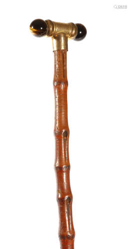 A George V swagger stick, the gilt metal handle with twin tiger's eyes and inscribed 'C. D. XMAS