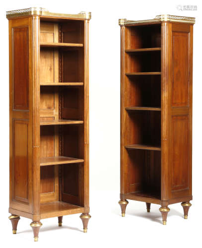 A pair of French mahogany open bibliotheques in Louis XVI style, each with a gilt brass pierced