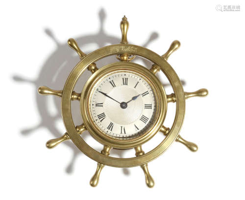 A novelty brass ship's wheel wall clock, with a lever escapement, the silvered dial with Roman