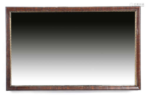 A George II red walnut wall mirror, the rectangular plate within a carved gilt slip and a moulded