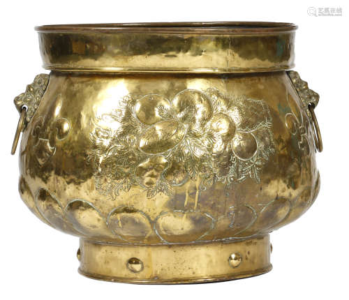 A late 19th century Dutch brass logbin or jardiniere, the body repousse decorated with fruits and