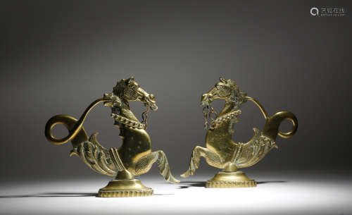 A pair of Italian Venetian brass hippocampi gondola ornaments, 19th century, 25cm high, 27.2cm wide.