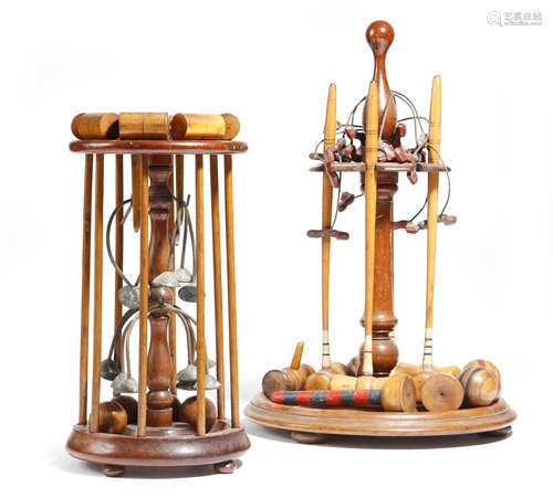 Two late Victorian table croquet sets, each with a mahogany stand supporting mallets, balls and