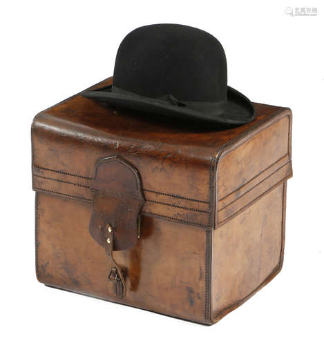 A leather top and bowler hat box, with brass mounts, impressed with initials 'C. P. J.',