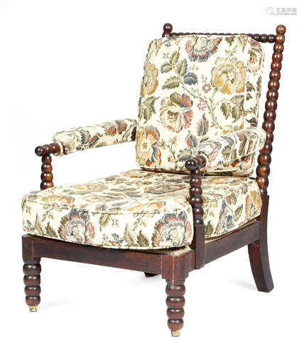 λ A George IV rosewood bobbin turned armchair in the manner of Gillows, originally on castors.