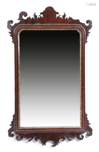 A George II red walnut fret-frame mirror, the original bevelled plate with cusped top corners, in