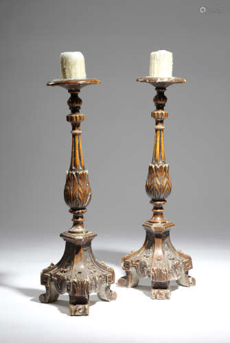 A pair of 19th century continental painted wood altar candlesticks, with fluted and leaf carved