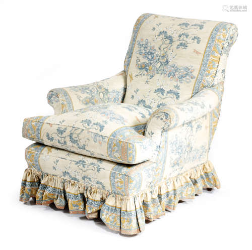 A late Victorian easy armchair, upholstered with peacocks and pines material by Warner & Sons, on