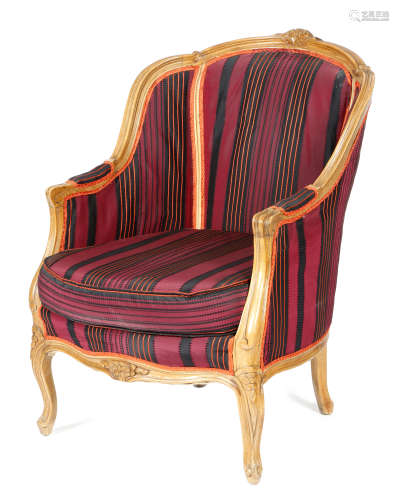 A Louis XV style beechwood bergere, with later silk upholstery, the moulded showframe carved with