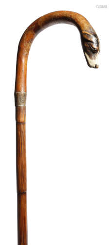 A late Victorian bamboo walking cane, the shepherd's crook handle carved and painted with the head