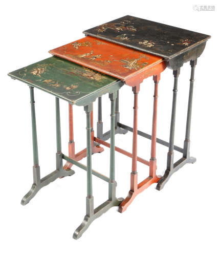 A nest of three japanned occasional tables, black, red and green and decorated with chinoiserie