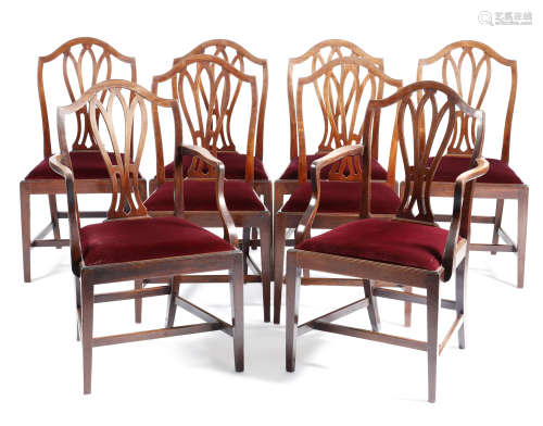 A set of eight George III mahogany dining chairs, each with a serpentine top rail, above a pierced