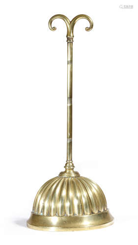 A Victorian brass doorstop, with a scroll handle and a lobed bell shaped weighted base, stamped with